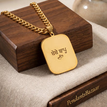 Load image into Gallery viewer, Gold pendant on a wooden stand with a blurred background
