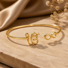 Charger l'image dans la galerie, Gold bracelet with unique designs on a wooden surface