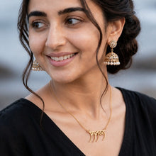Charger l'image dans la galerie, Woman with styled hair and jewelry against a blurred natural background