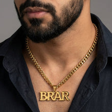 Load image into Gallery viewer, Man wearing a gold chain necklace with a 'BRAR' pendant against a gray background