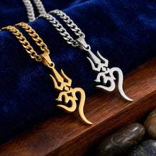 Load image into Gallery viewer, Two necklaces, one gold and one silver, with intricate designs on a blue fabric background.