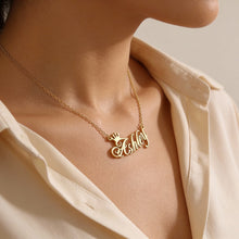 Load image into Gallery viewer, Gold necklace with 'Ashley' pendant worn by a person in a cream shirt.