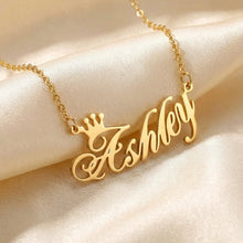 Load image into Gallery viewer, Gold necklace with 'Ashley' pendant on a beige fabric background