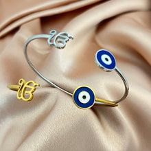 Load image into Gallery viewer, Two bracelets with eye designs on a beige fabric background
