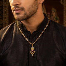 Load image into Gallery viewer, Man wearing a black shirt with a gold necklace featuring an Om symbol, set against a patterned wall.
