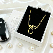 Load image into Gallery viewer, Gold necklace in a box with Tesla key fob and pearl decorations on a white surface
