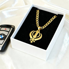 Charger l'image dans la galerie, Gold necklace with a symbol in a box next to a BMW key fob on a white surface

